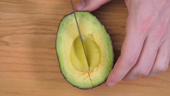 Cuttong Avocado Half With Knife On Cutting Board 01