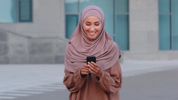 Portrait of Muslim Young Woman User Businesswoman Islamic Girl Student in Pink Hijab on Street alt