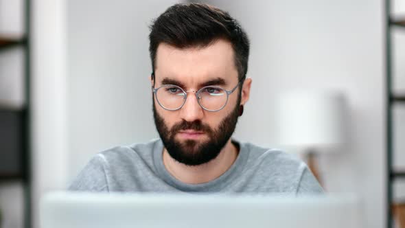 Focused Modern Man in Eyeglasses Browsing Internet Wireless Connection Web Page Use Laptop Pc