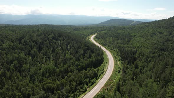 Winding Road in the West Siberian Taiga Ecoregion alt