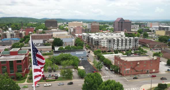 Huntsville, Alabama skyline with drone video still with American flag flying. alt