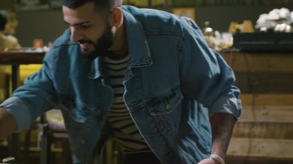 Young happy man playing table football