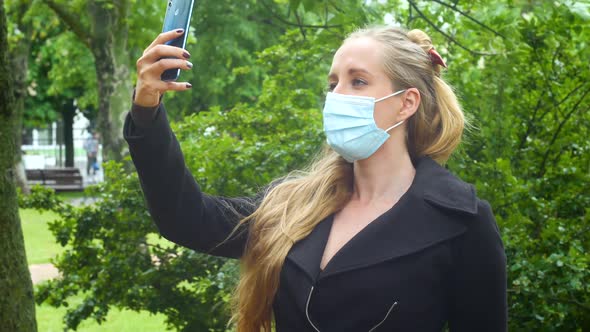 Beautiful Girl In A Summer Park Takes A Selfie