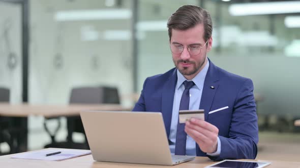 Online Payment Success on Laptop for Young Businessman  alt