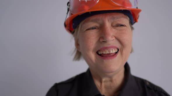 Portrait of a Mature Woman Builder in a Helmet