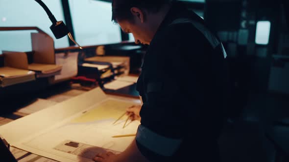 Marine Navigational Officer During Navigational Watch on Bridge . He Does Chart Correction alt