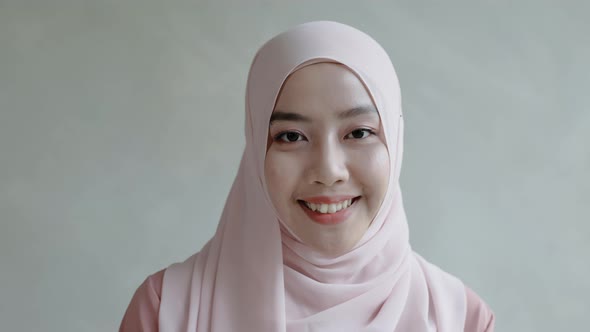 Close-up, beautiful Muslim girl smiling in hijab