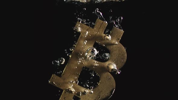 Golden Bitcoin Symbol Falls In Water