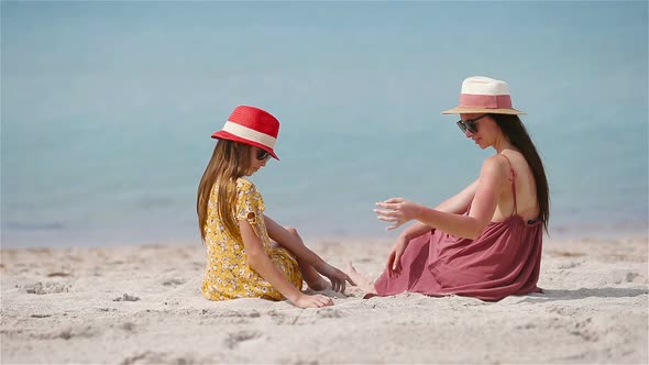 Beautiful Mother and Daughter at Caribbean Beach Enjoying Summer Vacation. alt