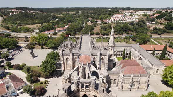 Flamboyant Gothic architecture of Batalha Monastery, Leiria, Portugal. Aerial dolly out alt