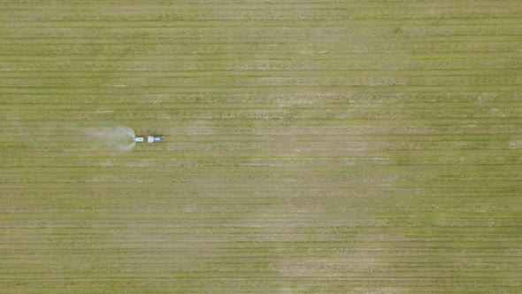 An Aerial View of a Tractor Spraying a Farmers Apple Crop In alt