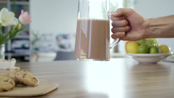 Taking And Putting Back Jug Of Chocolate Milk