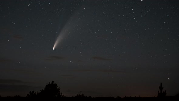 The Comet Moves Across the Night Sky Among the Stars alt