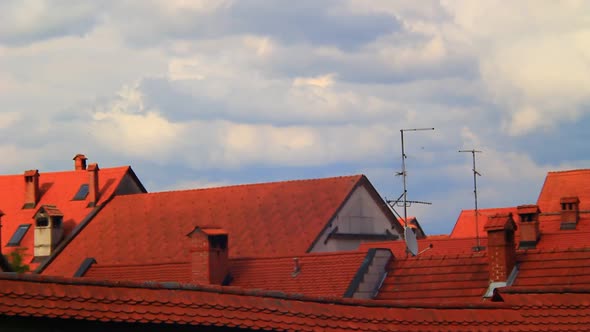 Red Roofs and Clouds Moving By