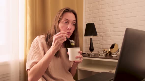 Relaxed Young Woman Comes Through Quarantine Eating Yogurt