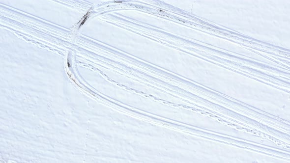 Descending on trails in the snow 4K drone video alt