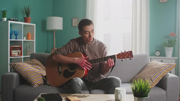 Young Man Is Playing Guitar alt