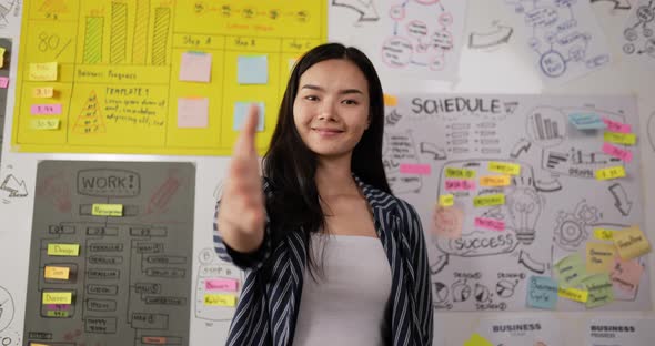 Happy female extending hand for handshake alt