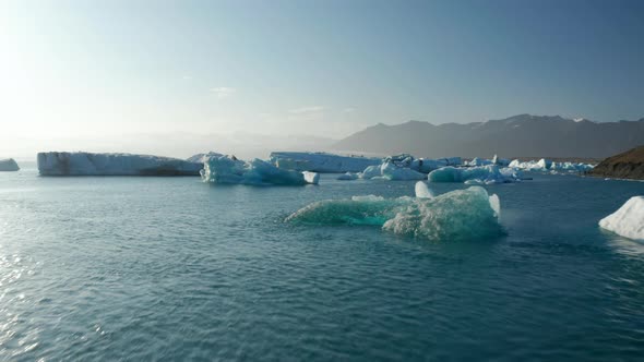Scenic Drone View Glacier Lagoon in Jokulsarlon Lake Iceland with Icebergs Floating on Water alt