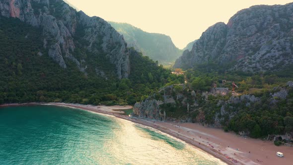 Tropical Beach with Rocky Mountains and Clear Sea Water alt