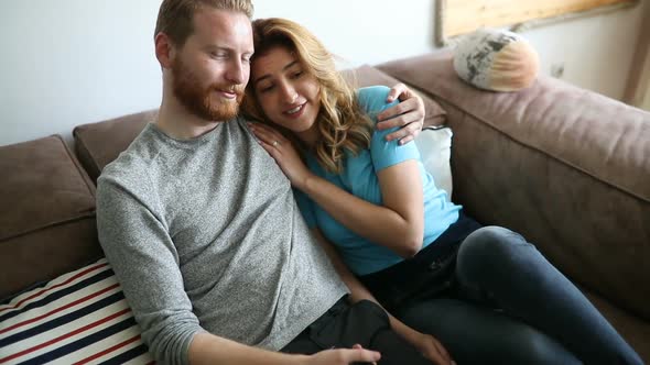 Beautiful Couple Watching Television at Home