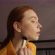 Closeup Side View of Serious Redhead Young Woman Applying Cosmetic Powder with Big Professional - VideoHive Item for Sale