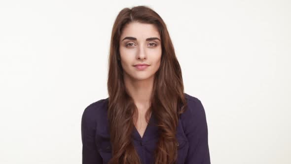 Young Attractive Caucasian Female in Dark Blue Shirt with Long Brown Hair Showing Ok and Winking on alt