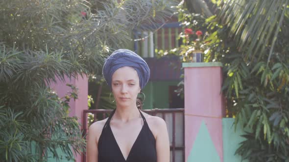 Portrait of Girl in Turban Posing Outdoors on Green Tropical Background Slow Motion. Smiling Young