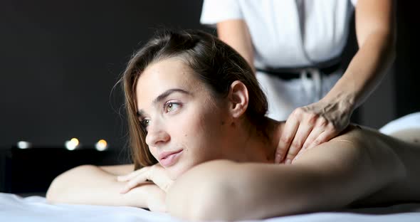 Young Woman Relaxing with Massage at Beauty Spa