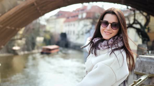 Attractive Smiling Female Tourist Admiring Amazing River View From City Embankment alt