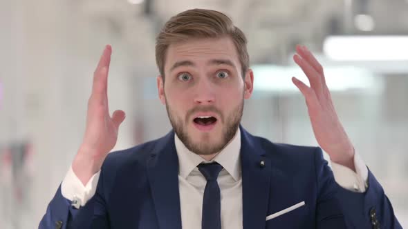 Disappointed Young Businessman Reacting Loss alt