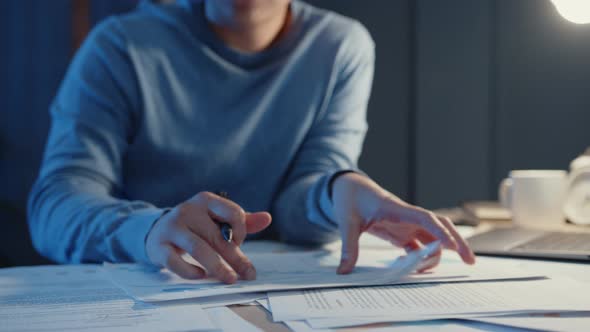 Asia freelance businessman video call meeting on tablet computer assignment paperwork.