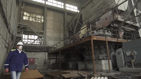 Engineer Wearing a White Helmet Oversees Industrial Granite Processing Slow Motion alt