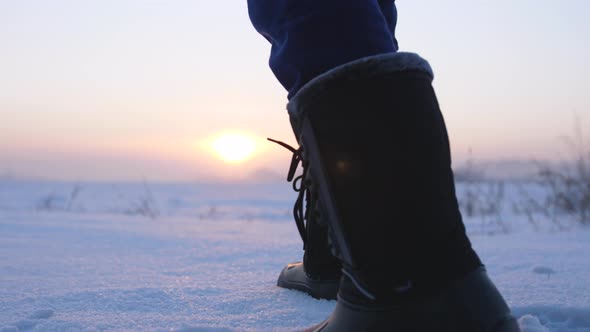 Male Feet Walking in Deep Snow