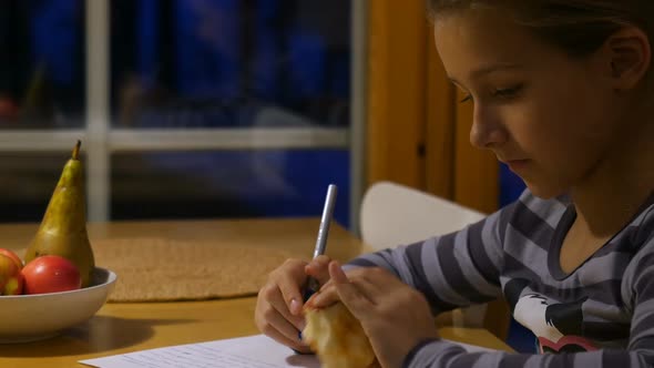 Pretty School Girl at Home, Writing a Homework. Child Sitting at Table and Write