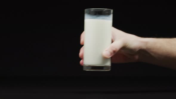 Putting down a filled glass of milk alt