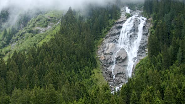 Grawa Waterfall in Rainy Pine Tree Forest in Stubai Austria alt