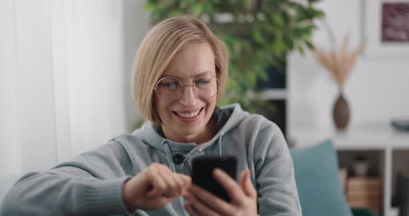 Woman Using Mobile on Sofa alt