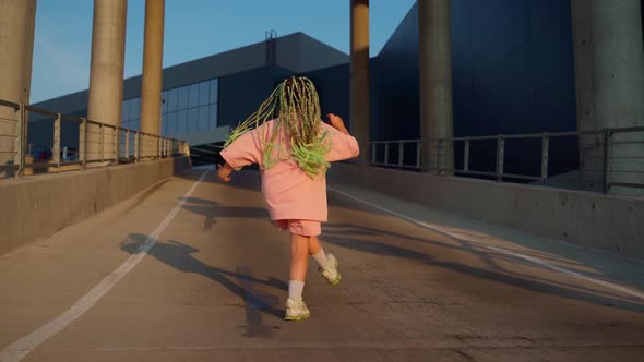 Young girl dancer dancing hip hop at car parking. Urban dancing freestyle in the city alt