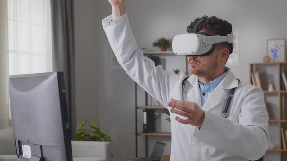 Professional Medical Male Doctor Working in Hospital Office Using Virtual Reality Technology alt