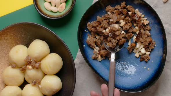 Vertical Flat Lay Video Chef Sprinkles Bread Crumbs on Potato Dumplings