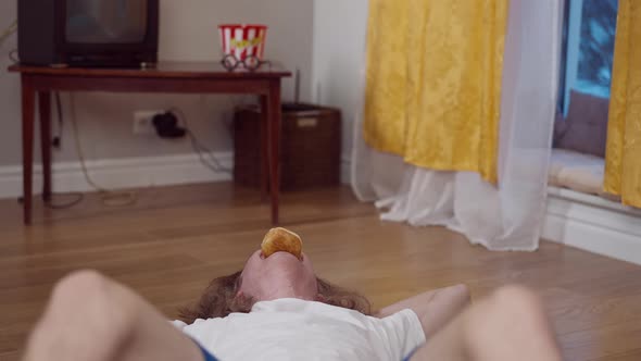 Laughing Skinny Weak Man Pumping Press Holding Donut in Mouth alt