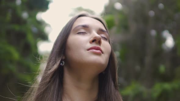 Woman in Closed Eyes Low Angle Shot, Beautiful Brunette Feels Nature Oneness alt