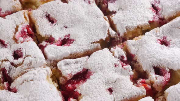 Sponge  cherry cake divided  on smaller pieces 4K2160p UHD tilting  footage - Sour cherry cake powde alt