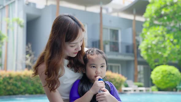 mother consoled her crying daughter by the pool in the inn