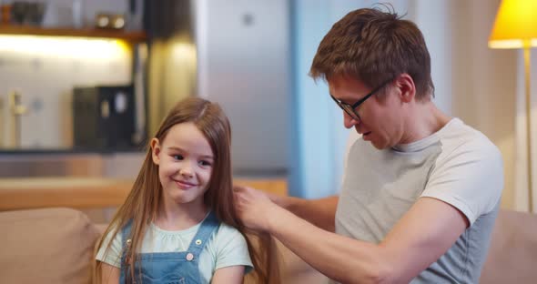 Caring Smiling Father Brushing Adorable Preschool Daughter Hair alt