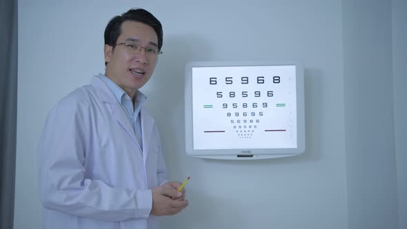 Optical shop concept. The ophthalmologist is testing a patient's eyesight by reading letters alt