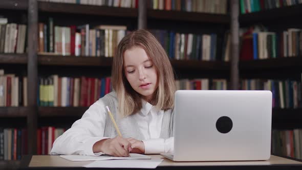 Close Up Portrait Schoolgirl Teach Lessons While at Home Sitting in the at the Table in Library alt