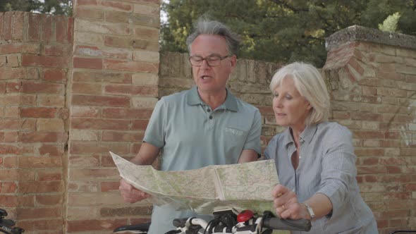 Senior couple looking at map on holiday