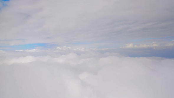 Layers of thick clouds viewed from airplane, gaining altitude, travelling by air alt